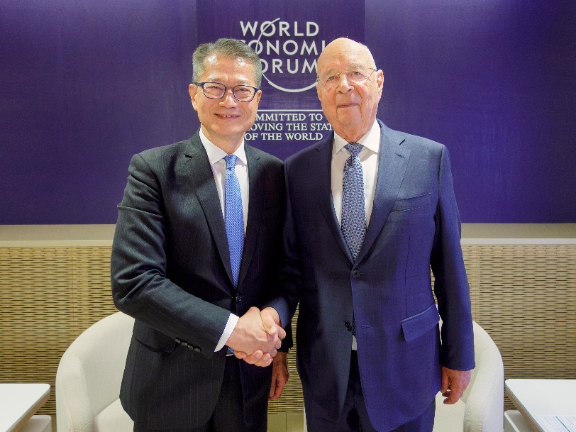 Mr Chan (left) meeting with the founder and executive chairman of the World Economic Forum, Professor Klaus Schwab.